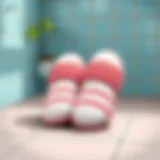 A pair of clean bathroom slippers on a tiled floor