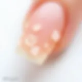 Close-up of artificial nails with adhesive residue